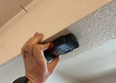 moisture meter testing a ceiling
